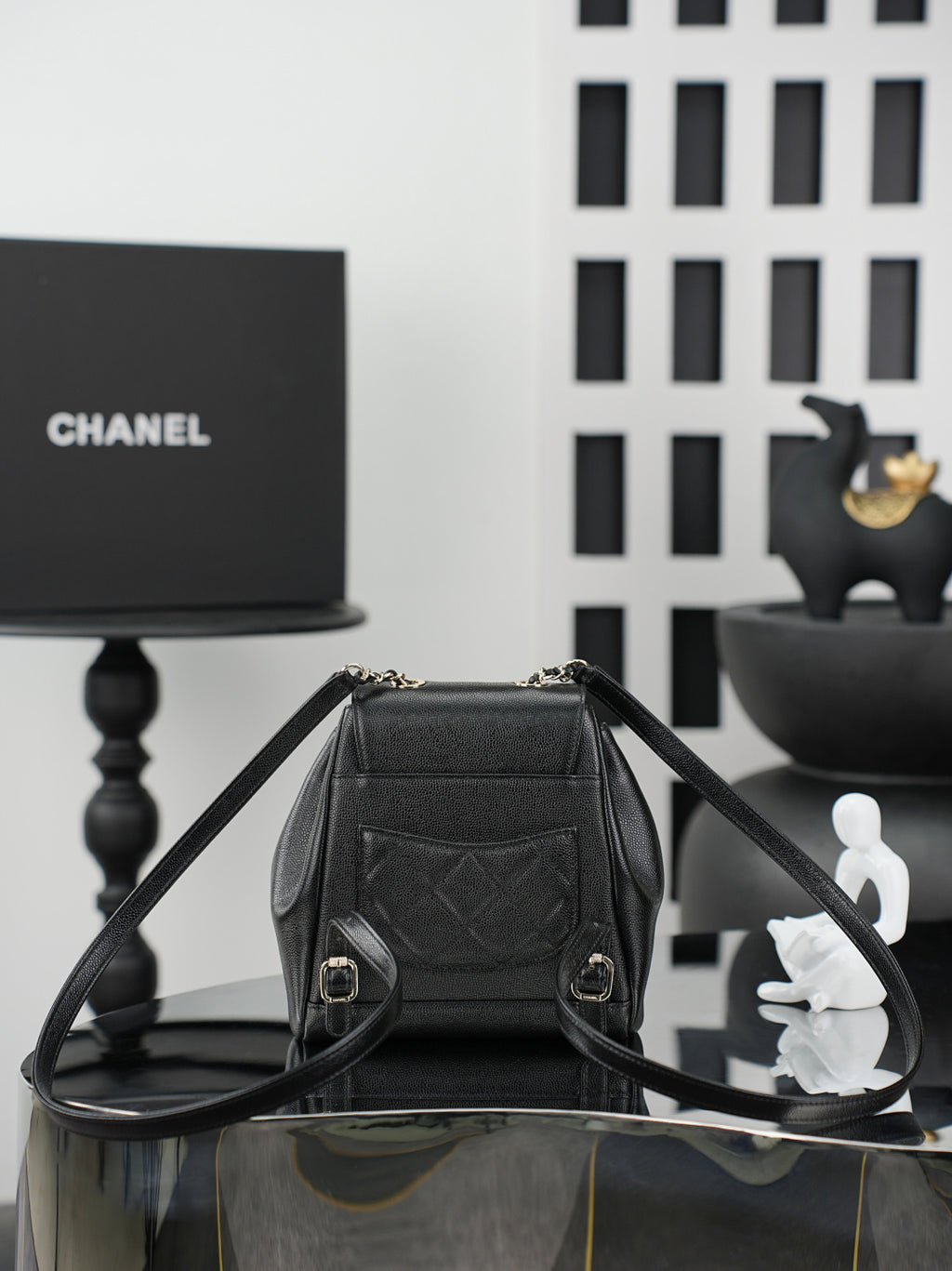 Chanel black bucket bag shown open with top handle and interior lining