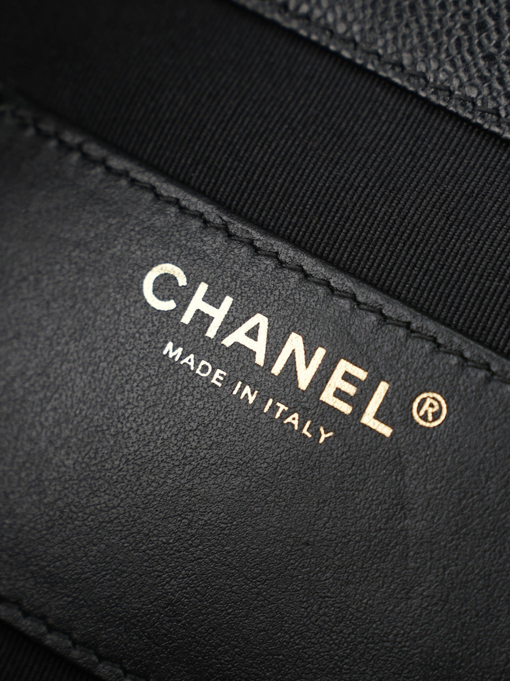 Chanel “Made in Italy” leather label on black bag interior panel