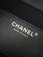 Chanel “Made in Italy” leather label on black bag interior panel