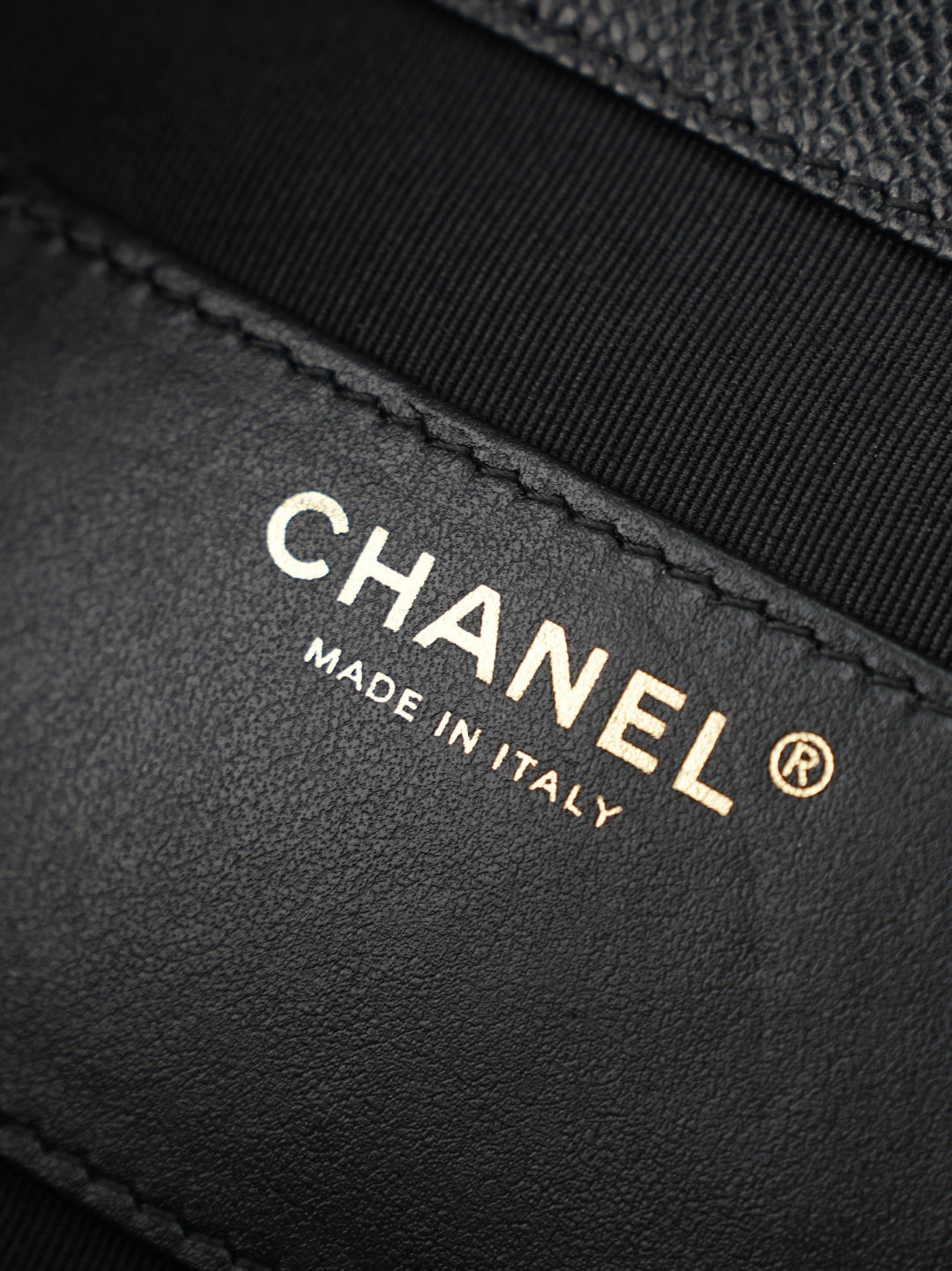 Chanel “Made in Italy” leather label on black bag interior panel