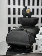 Chanel black mini bucket bag with zip top and gold-tone hardware