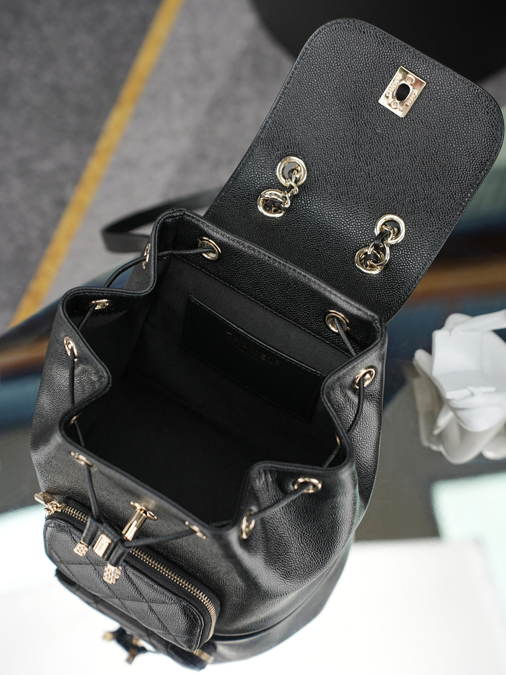 Chanel black mini bucket bag open view with front zipper pocket and hardware