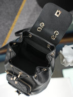 Chanel black mini bucket bag open view with front zipper pocket and hardware