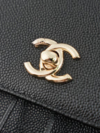 Chanel gold-tone CC charm on textured black leather bag