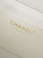 White bag interior label reading CHANEL, MADE IN ITALY on fabric