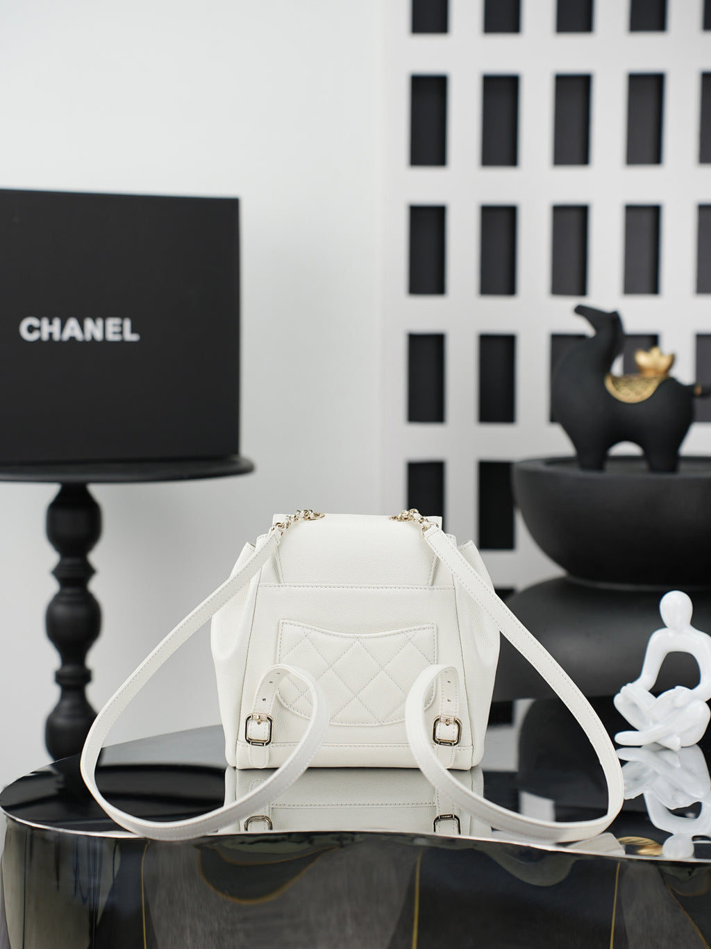 White leather-like bucket bag with quilted back, gold hardware, drawstring closure