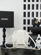 White leather-like bucket bag with quilted back, gold hardware, drawstring closure