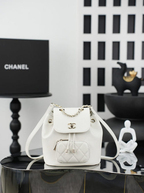 White leather-like drawstring bucket bag with gold chain shoulder strap and front flap