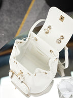Open white bucket bag with gold hardware, chain strap, and interior pocket