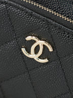 Chanel CC logo on dark textured leather with gold-tone emblem