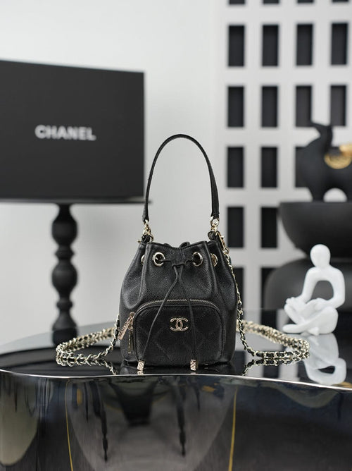 Chanel drawstring bag in dark leather with gold chain strap and CC logo front
