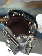 Chanel drawstring bag interior with dark burgundy lining and zip pocket details