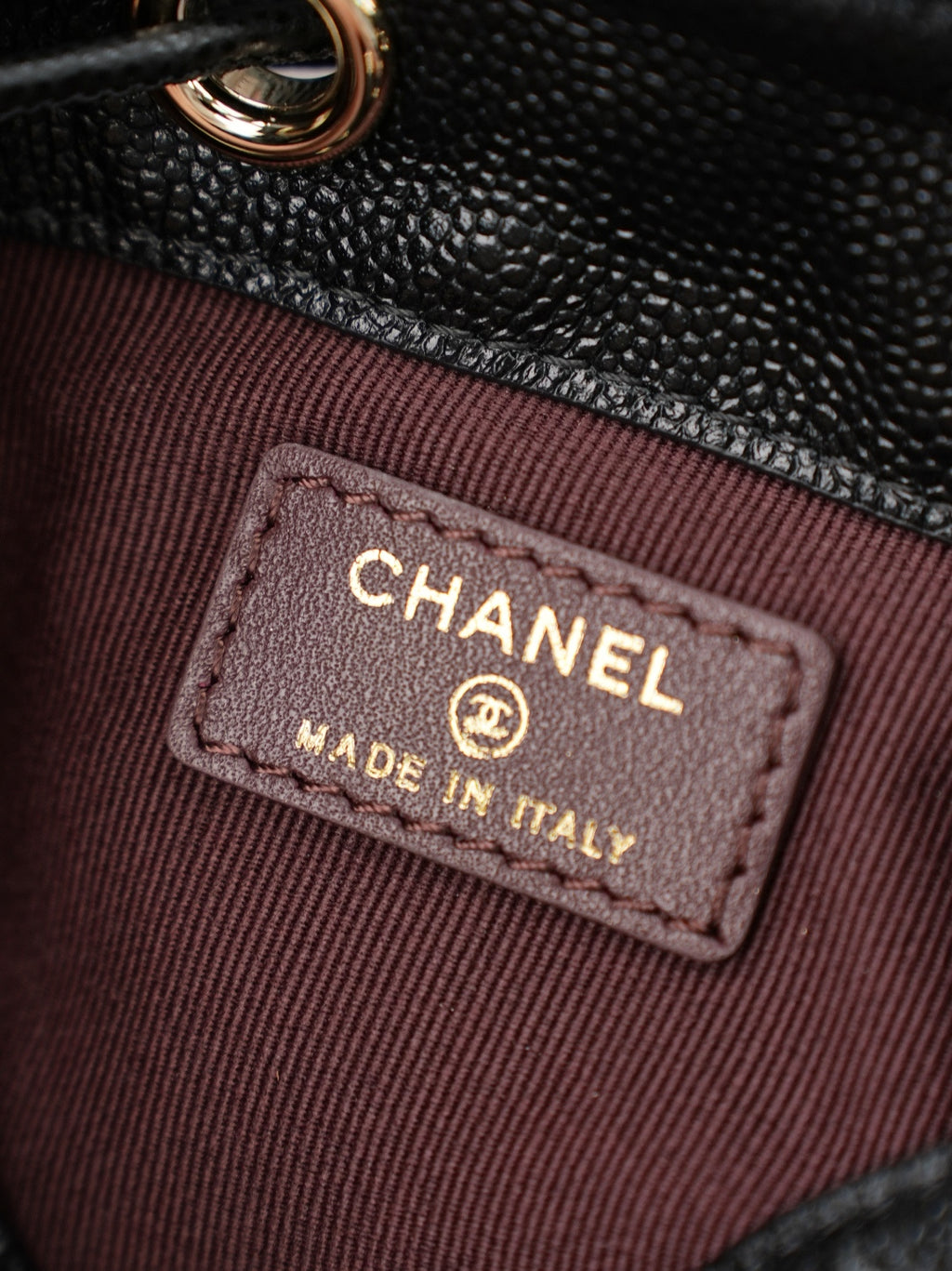 Chanel interior label reading CHANEL and MADE IN ITALY on burgundy lining