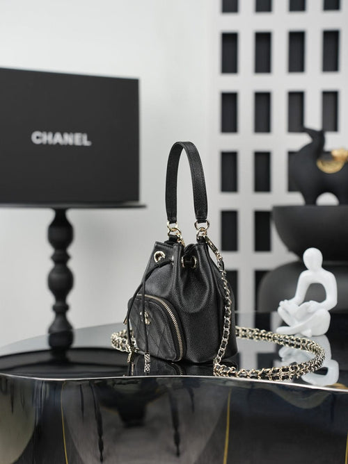 Chanel drawstring bucket bag in dark leather with side zip pocket and gold chain