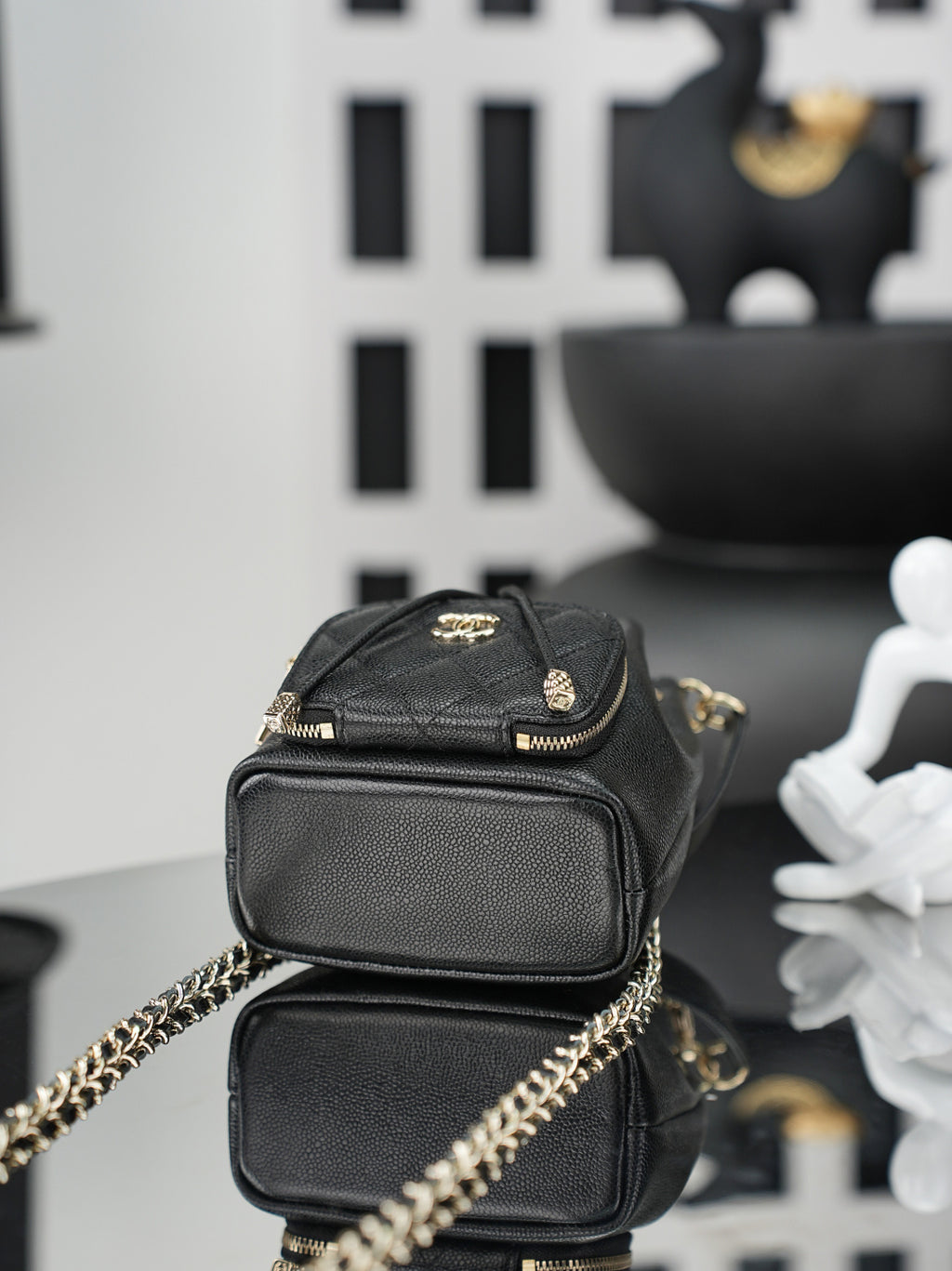 Chanel small leather bag with gold hardware, front flap pocket, and chain strap