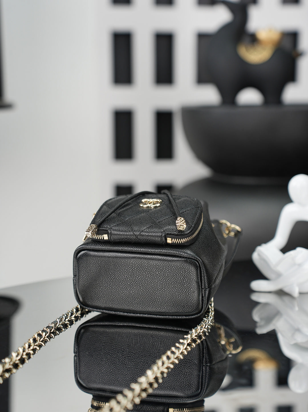 Chanel small leather bag with gold hardware, front flap pocket, and chain strap