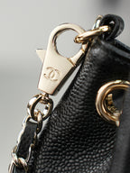 Chanel padlock clasp and gold-tone ring hardware on dark leather strap