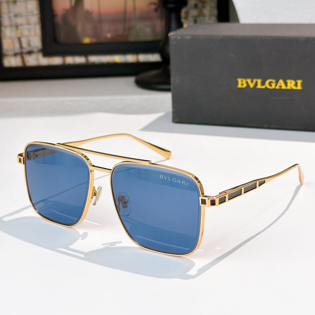 Sunglasses with gold frames and blue gradient lenses, rectangular rounded shape