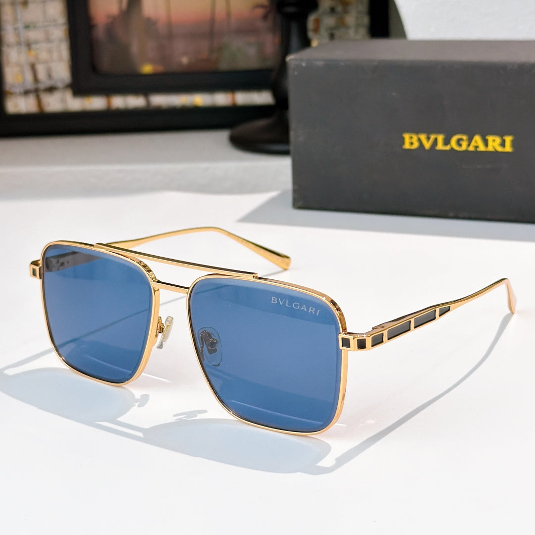 Sunglasses with gold frames and blue gradient lenses, rectangular rounded shape