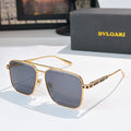 Sunglasses with gold frames and blue gradient lenses, rectangular rounded shape