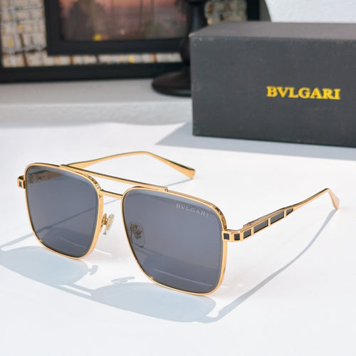 Sunglasses with gold frames and blue gradient lenses, rectangular rounded shape