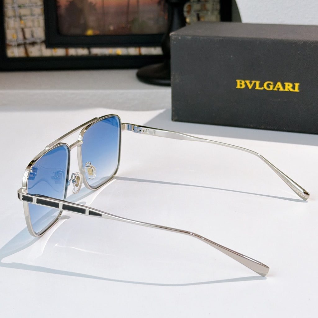 Sunglasses with silver frames and blue gradient lenses, side view with temple arms
