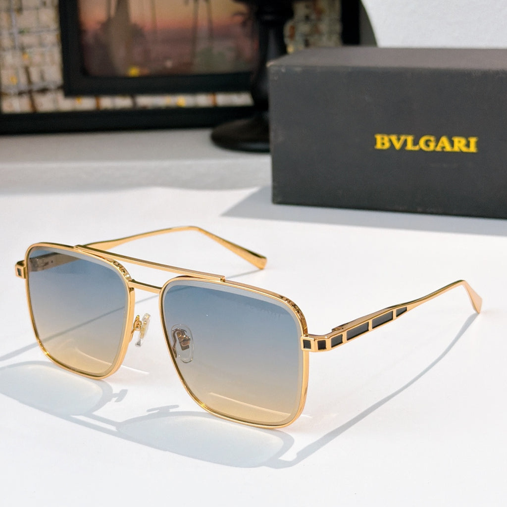 Sunglasses with gold frames and light blue gradient lenses, rectangular rounded shape