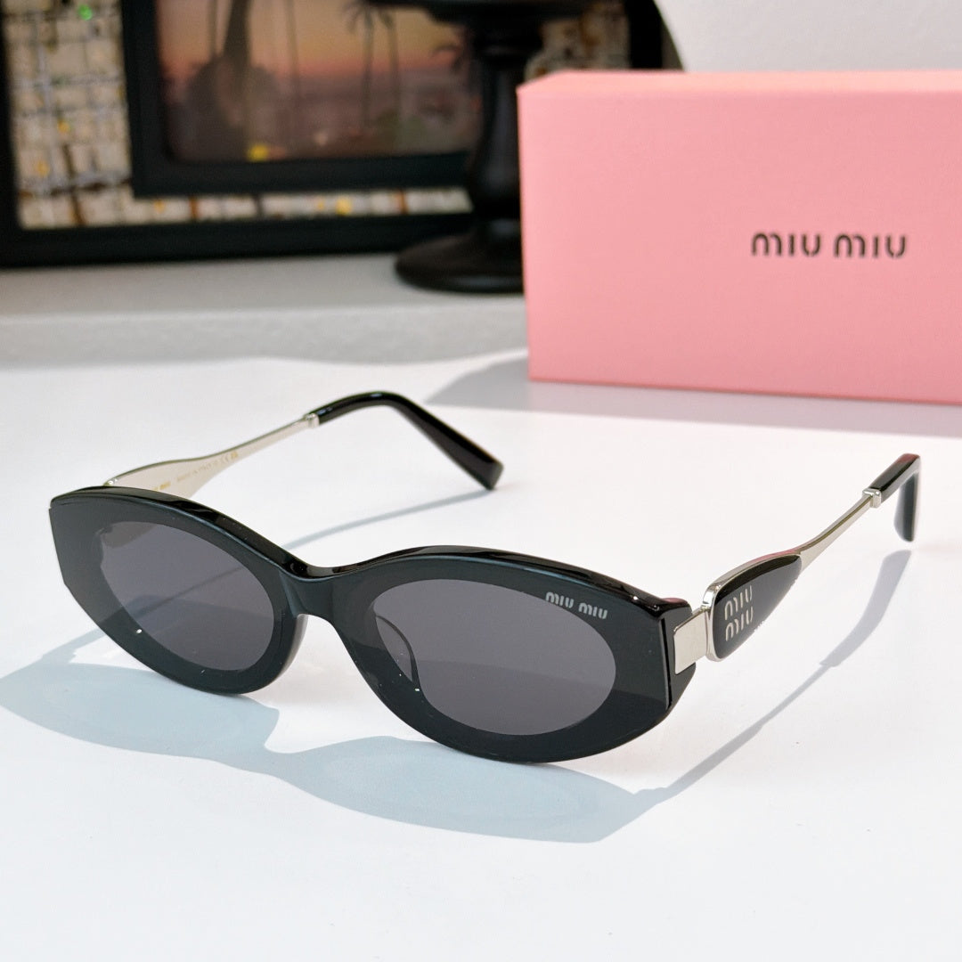 Black oval sunglasses with dark lenses and silver-toned temple accents