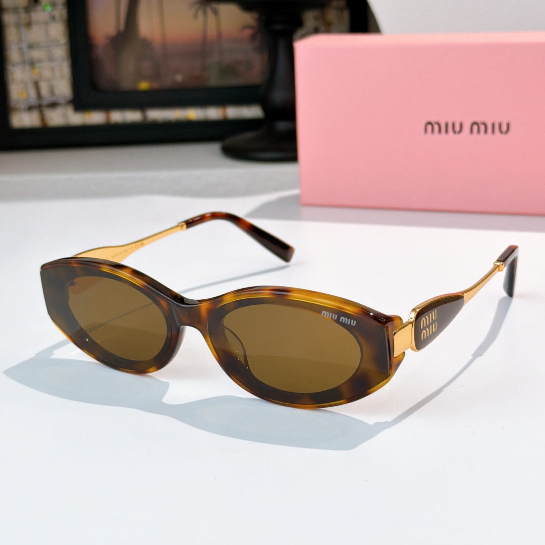 Tortoiseshell oval sunglasses with dark lenses and gold temple accents
