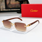 Sunglasses with gold frames and dark brown-tinted lenses, rectangular cat-eye shape