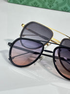 Gucci sunglasses close-up: gold-tone frame pair on display, tinted lenses