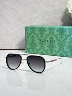 Gucci sunglasses with black frame and dark tinted lenses, front view