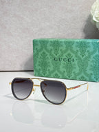 Gucci sunglasses with gold-tone frame, dark tinted lenses and round corners