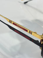 Gucci sunglasses temple detail with gold trim and multicolor stripe