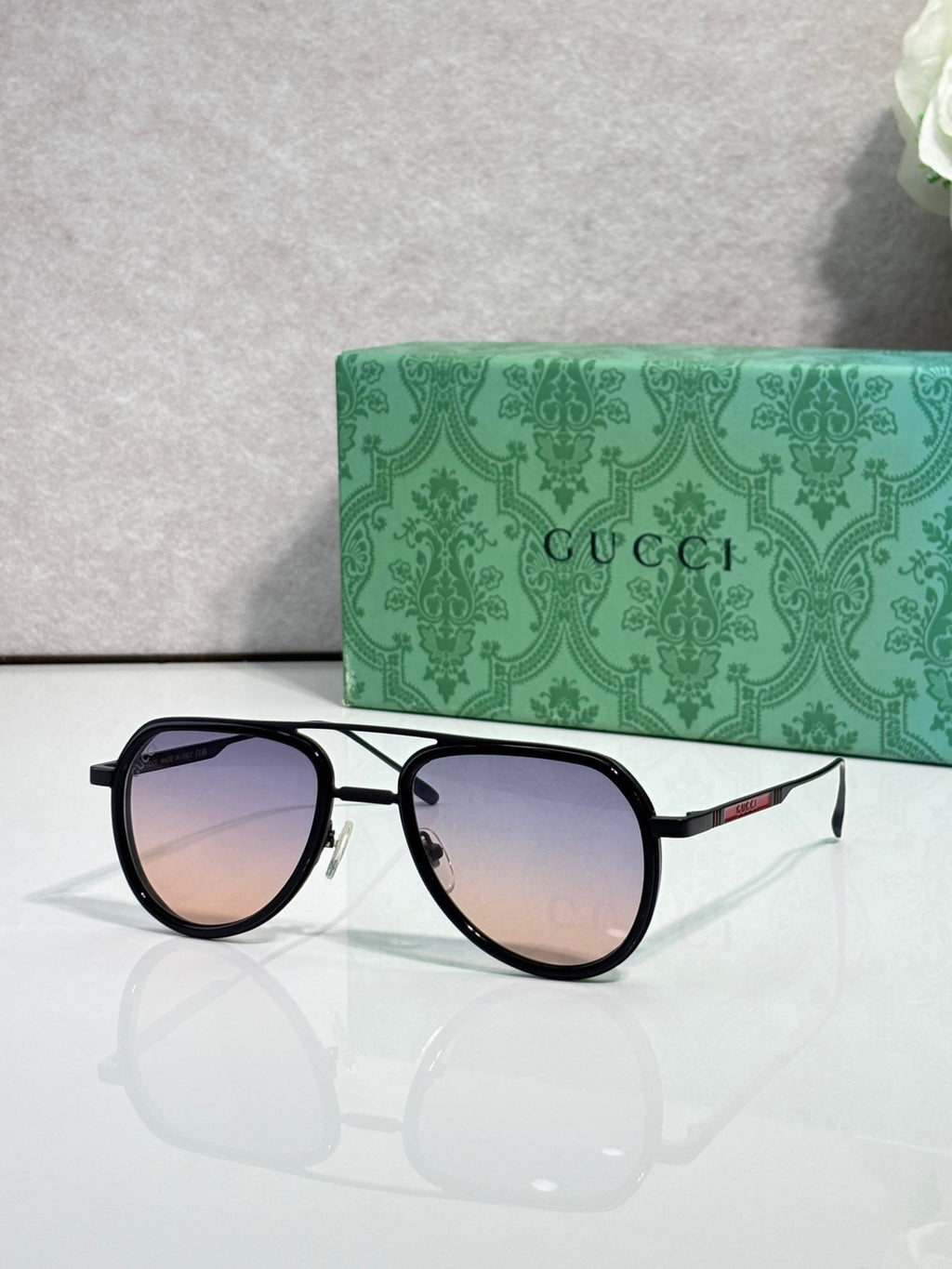 Gucci sunglasses with black frame and gradient lenses, side profile