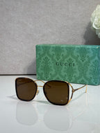 Brown metal sunglasses with dark brown tinted lenses and square rounded frames