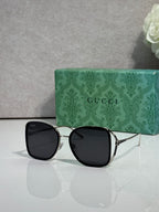 Black metal sunglasses with dark tinted lenses and square rounded frames
