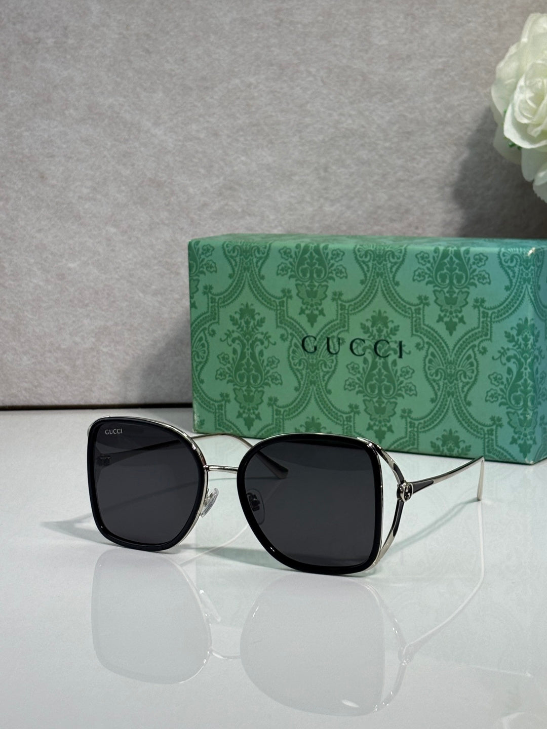 Black metal sunglasses with dark tinted lenses and square rounded frames