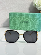 Square sunglasses with gold-tone frames and dark tinted lenses