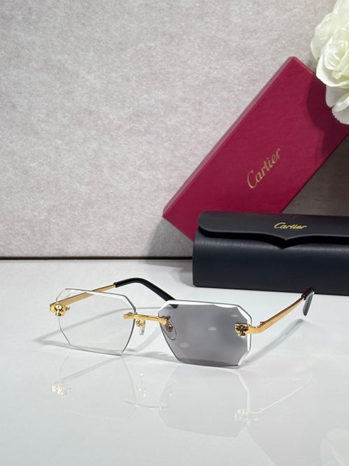 Cartier rectangular eyeglasses with black temples, clear gray lenses, gold hinges