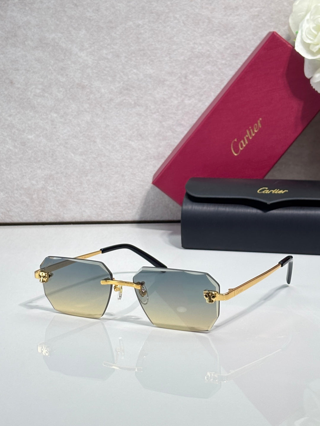 Cartier rectangular eyeglasses with black temples, pale yellow lenses, gold accents