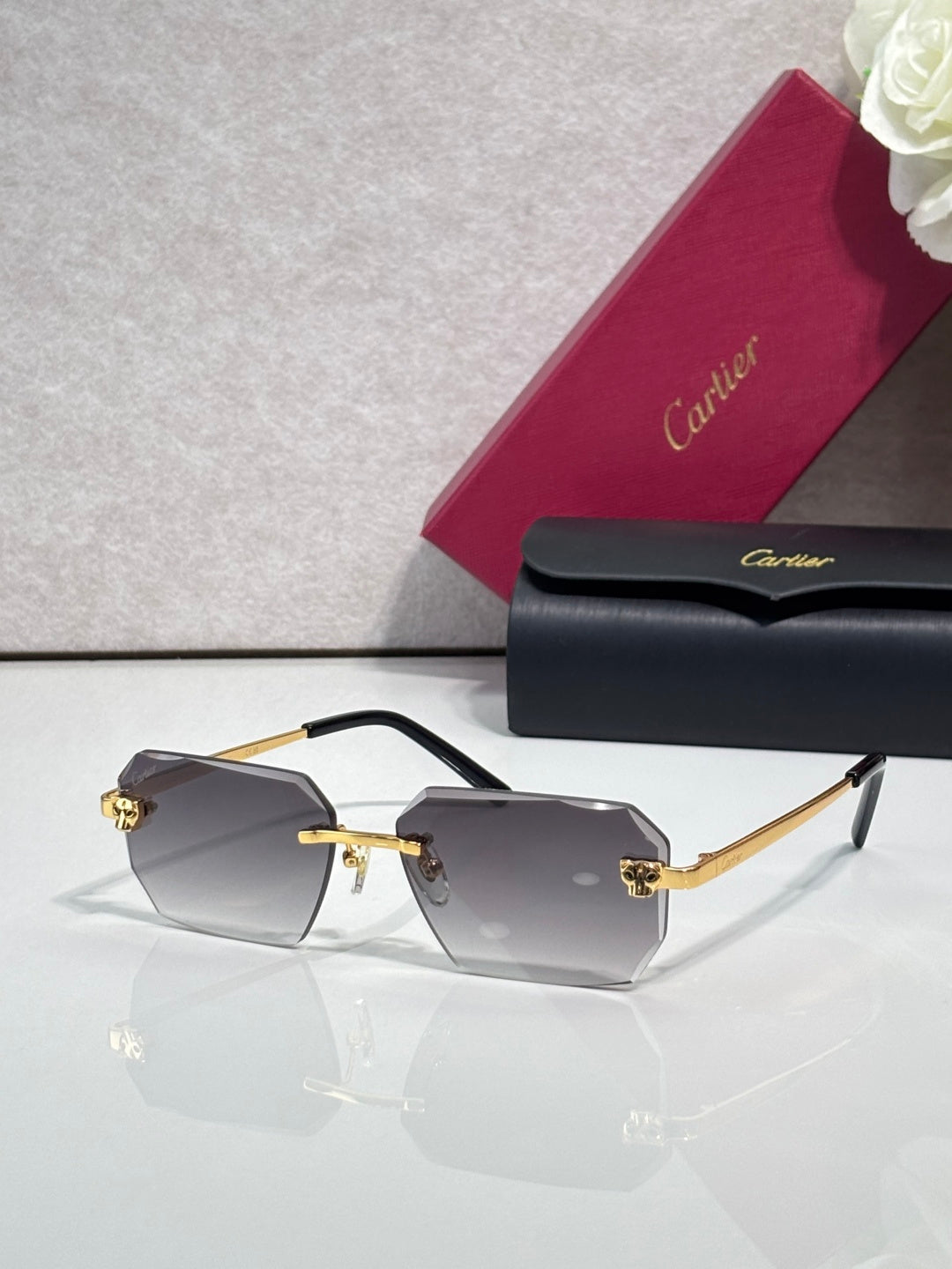 Cartier rectangular eyeglasses with black temples, dark gray lenses, gold hinges