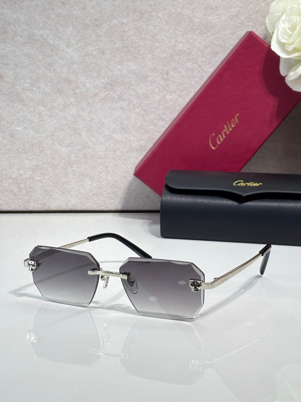 Cartier rectangular eyeglasses with black temples, smoky gray lenses, gold hardware