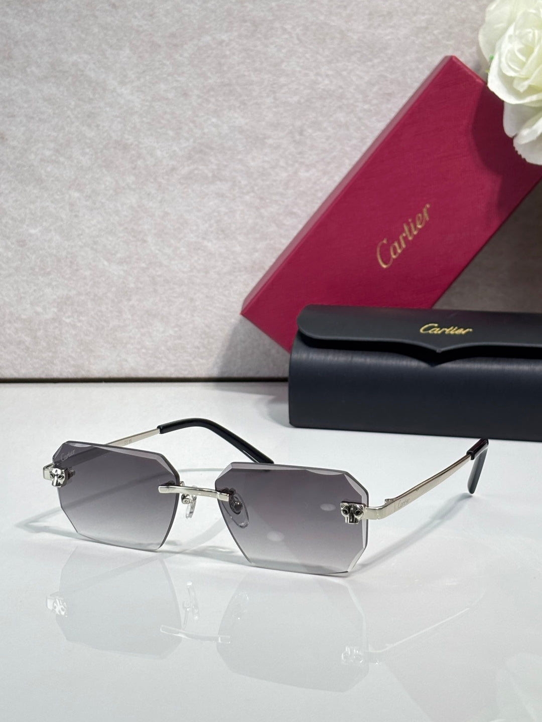 Cartier rectangular eyeglasses with black temples, smoky gray lenses, gold hardware