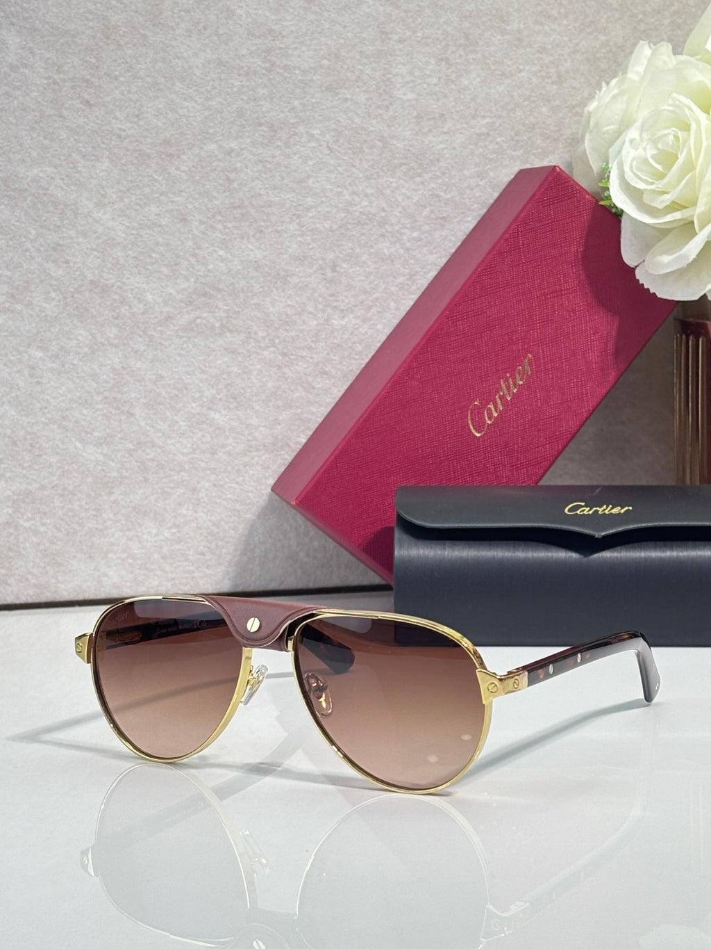 Cartier oval sunglasses with warm brown lenses and gold-tone frame