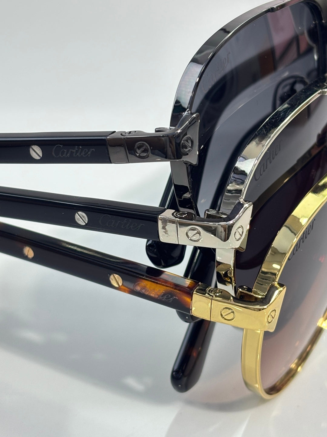 Cartier sunglasses close-up: gold hinge hardware and dark lens temple detail