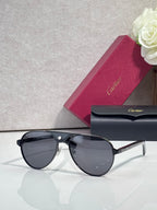 Cartier oval sunglasses with dark lenses and black frame, thin gold-tone details