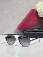 Cartier oval sunglasses with dark lenses and metallic frame with gold-tone accents