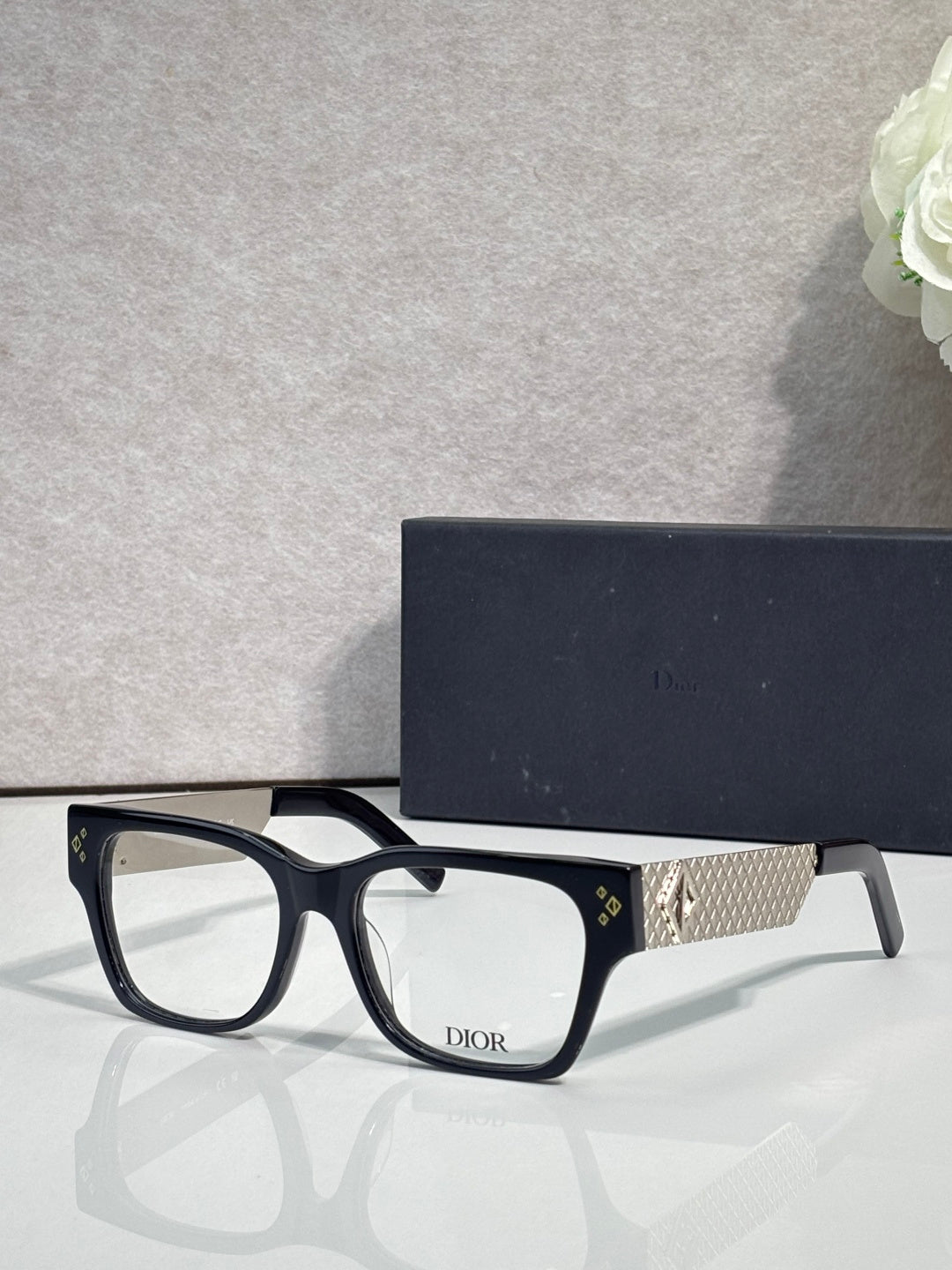 Dior eyeglasses with dark frames and textured gold temple detail with Dior logo