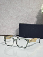 Dior eyeglasses with clear green frames and textured gold temple detail
